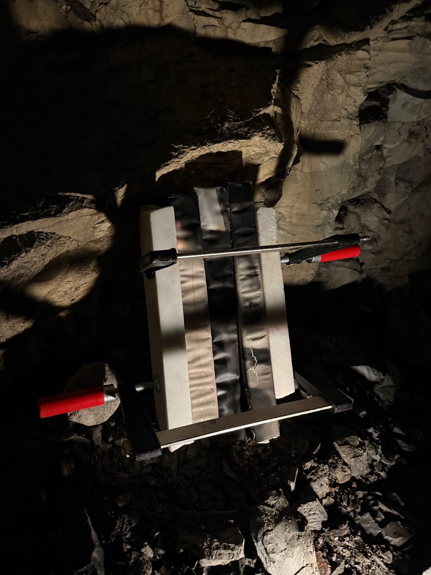 Clamped marble and paper panel lit from the side in the cave