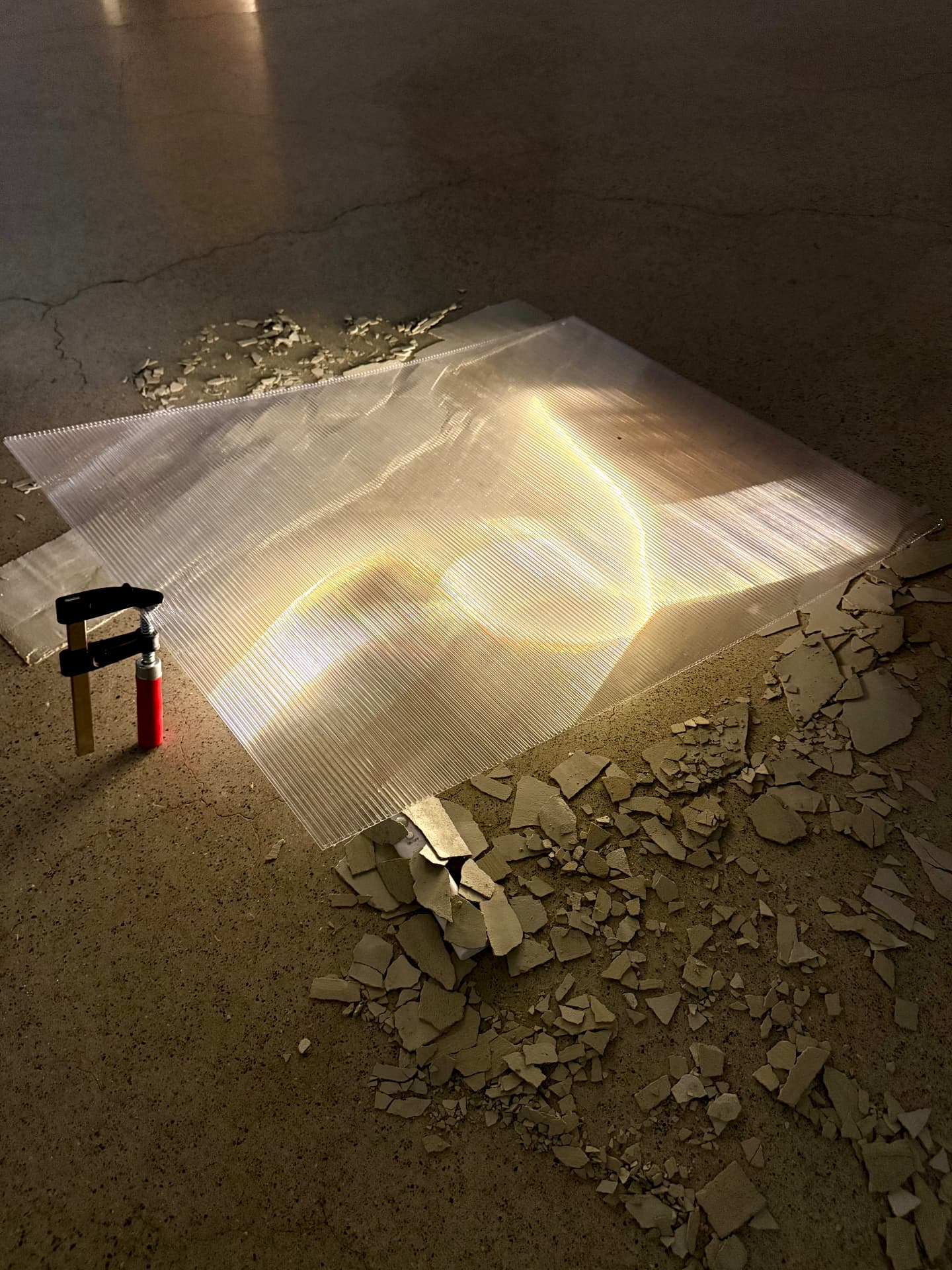 Stack 3 lit from beneath on a concrete floor