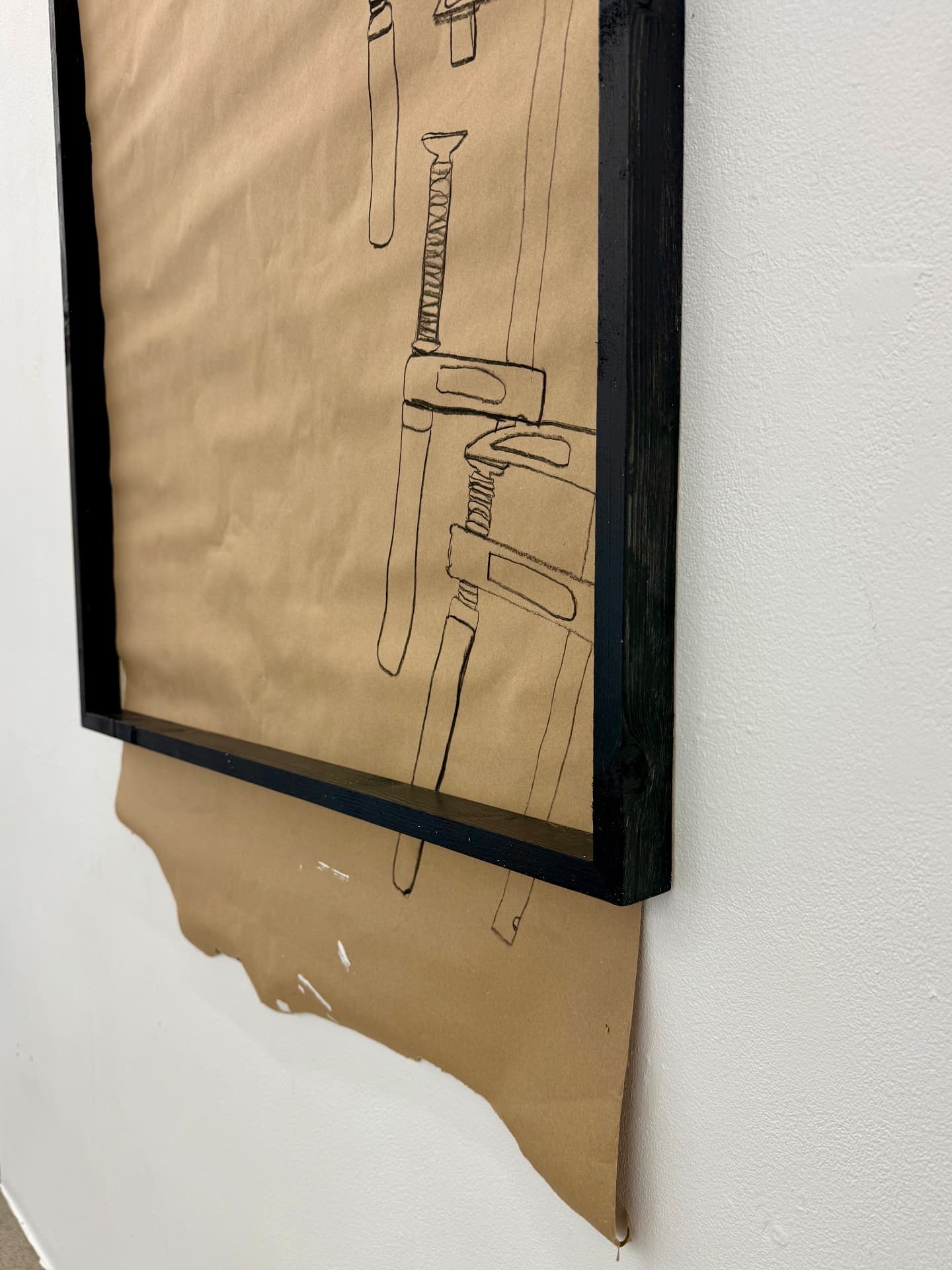 Detail of charcoal clamp drawing and torn paper edge