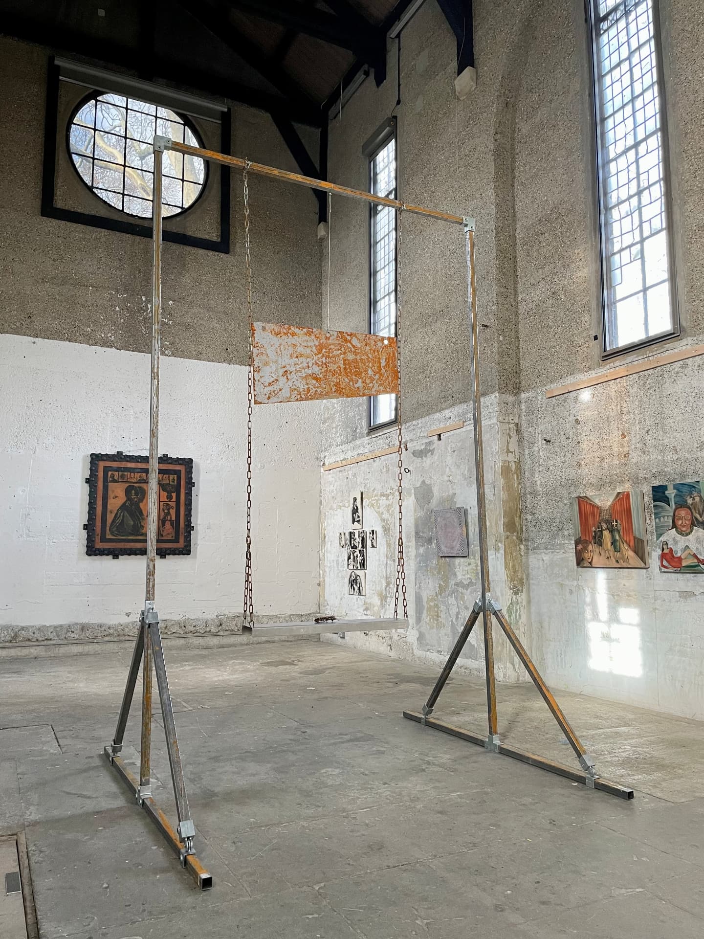 Side view of the steel gantry and suspended panel with light falling through windows