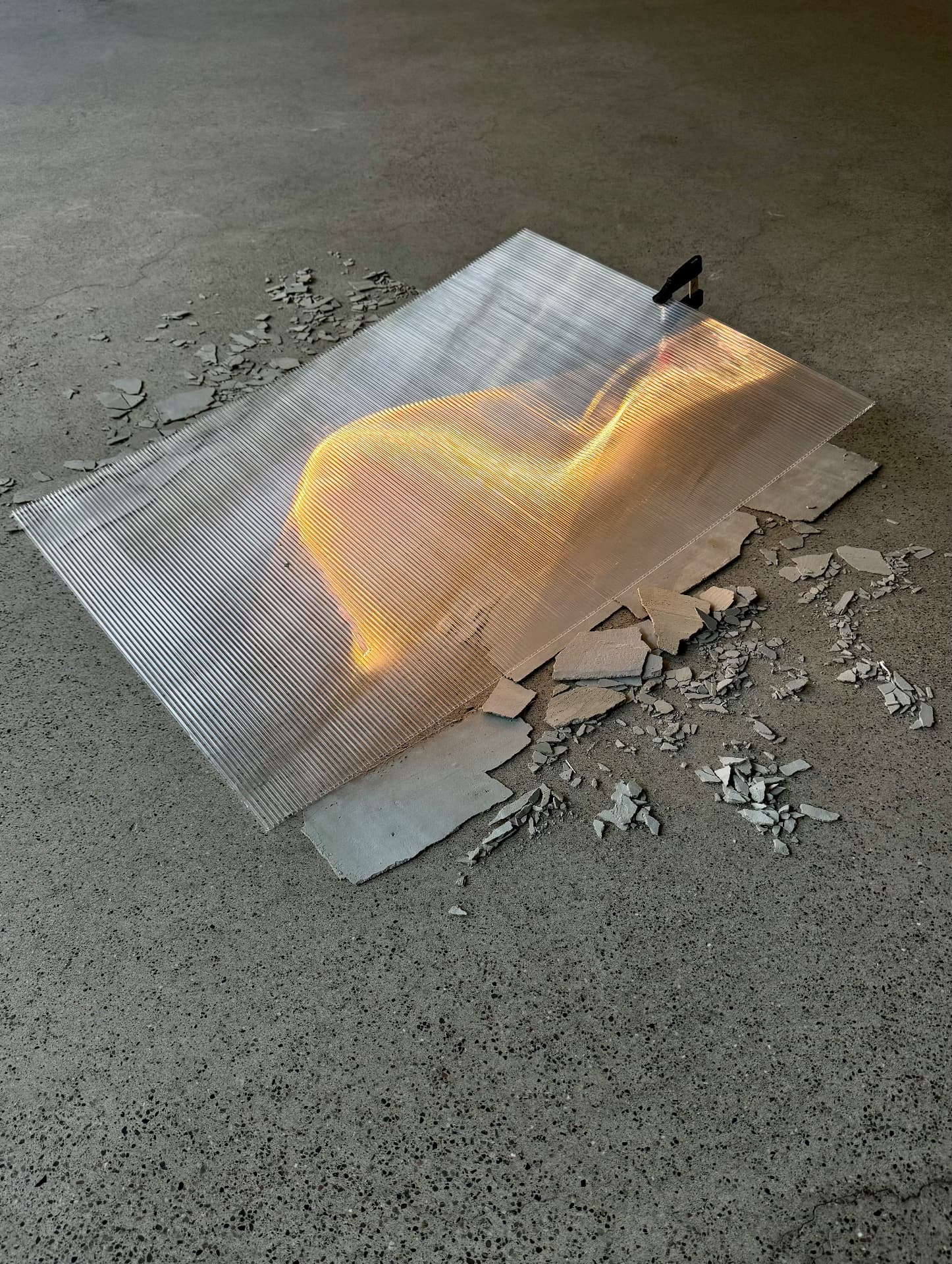 Close view of the lit polycarbonate sheet with warm light passing through