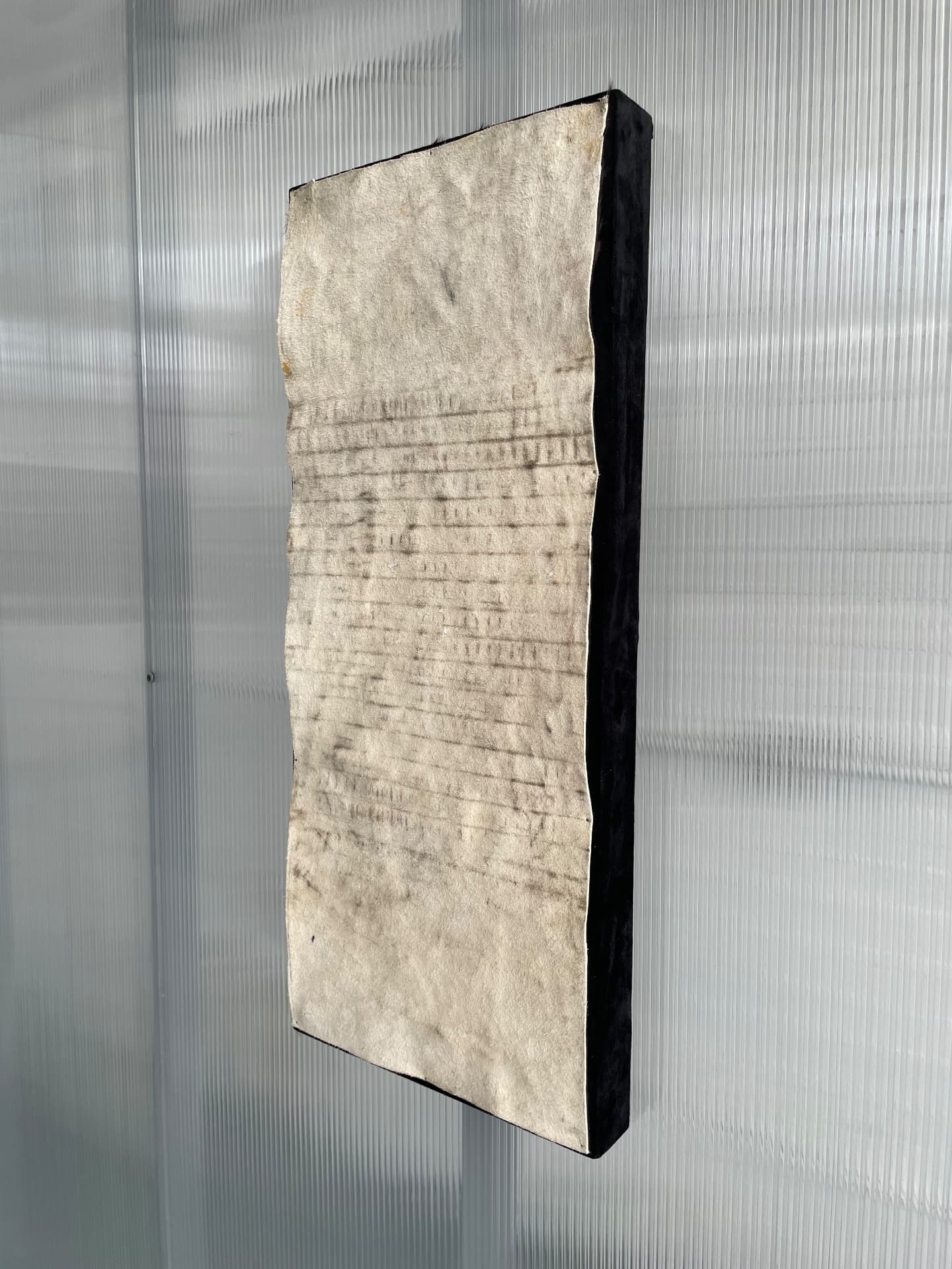 Side view of the cowhide panel showing its depth and dark edge