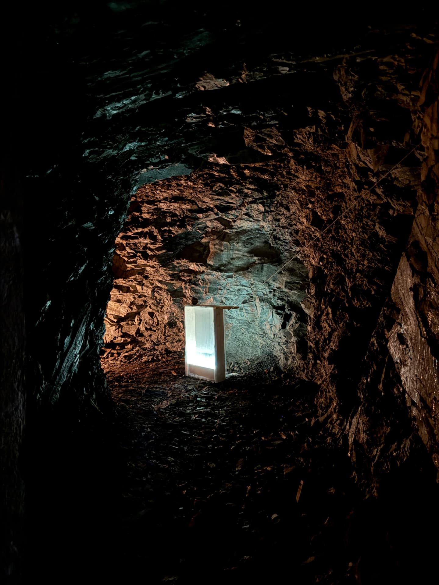 Glowing vitrine set into the cave wall