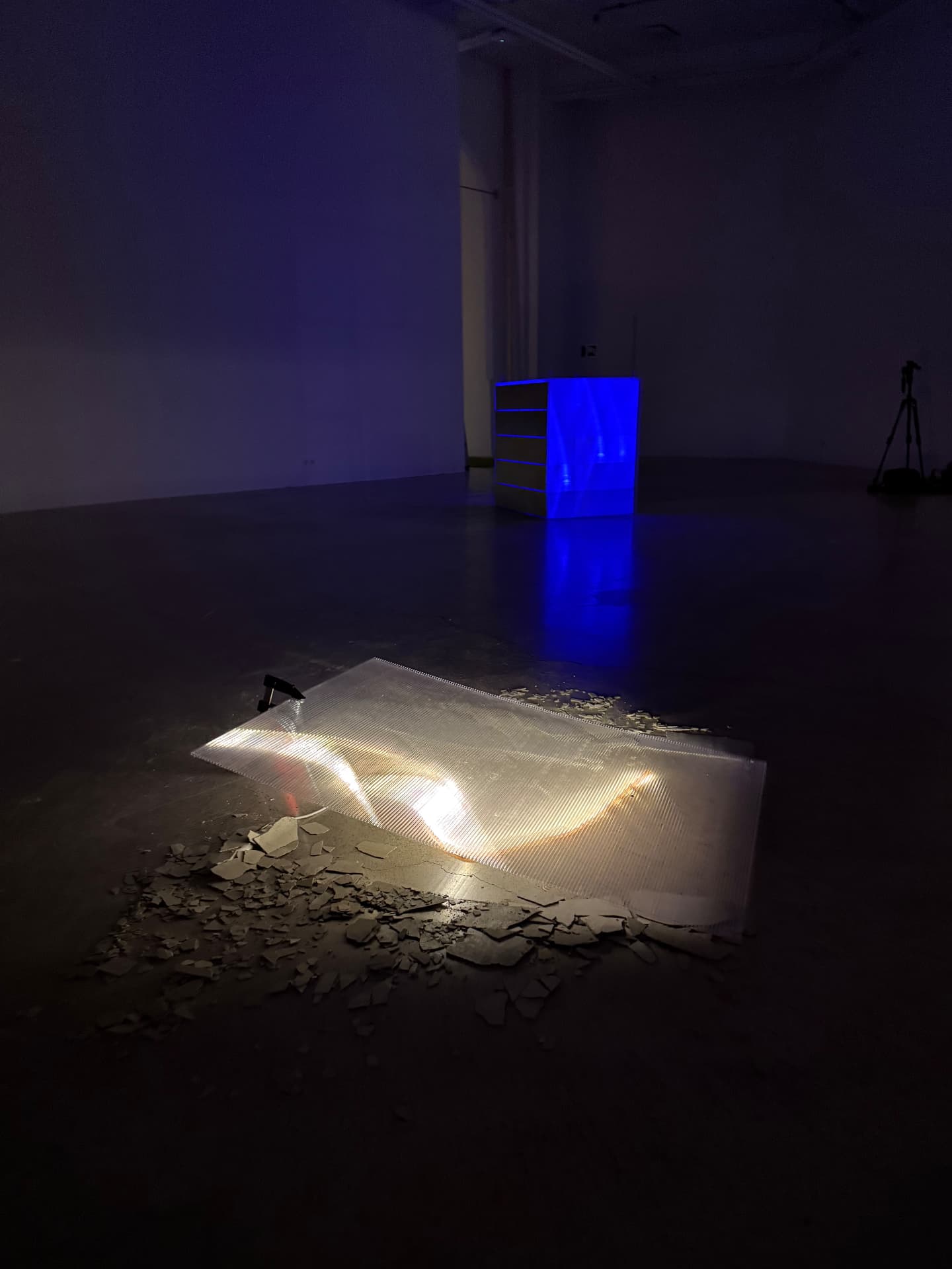 Wide view of Stack 6 glowing blue beside a lit panel on the floor