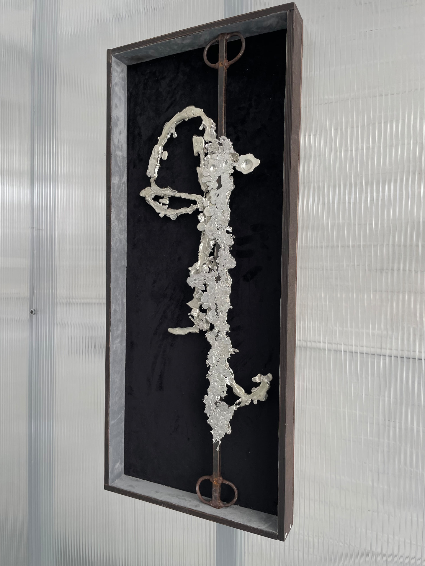 Undertow in its steel and wood box frame