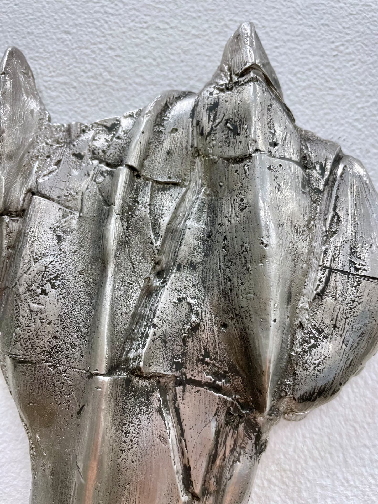 Close-up of the sand cast tin horse mask surface
