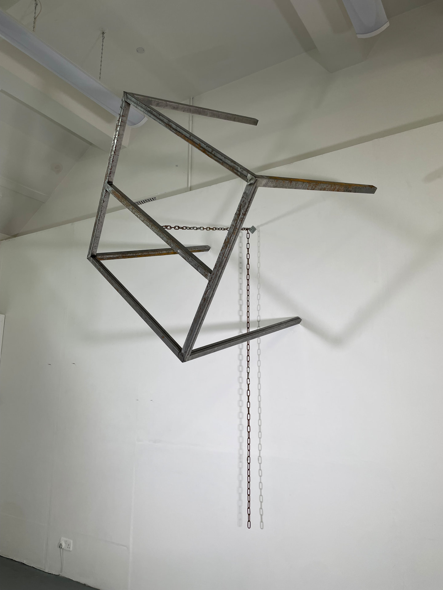 Suspended steel frame with chains hanging from the ceiling